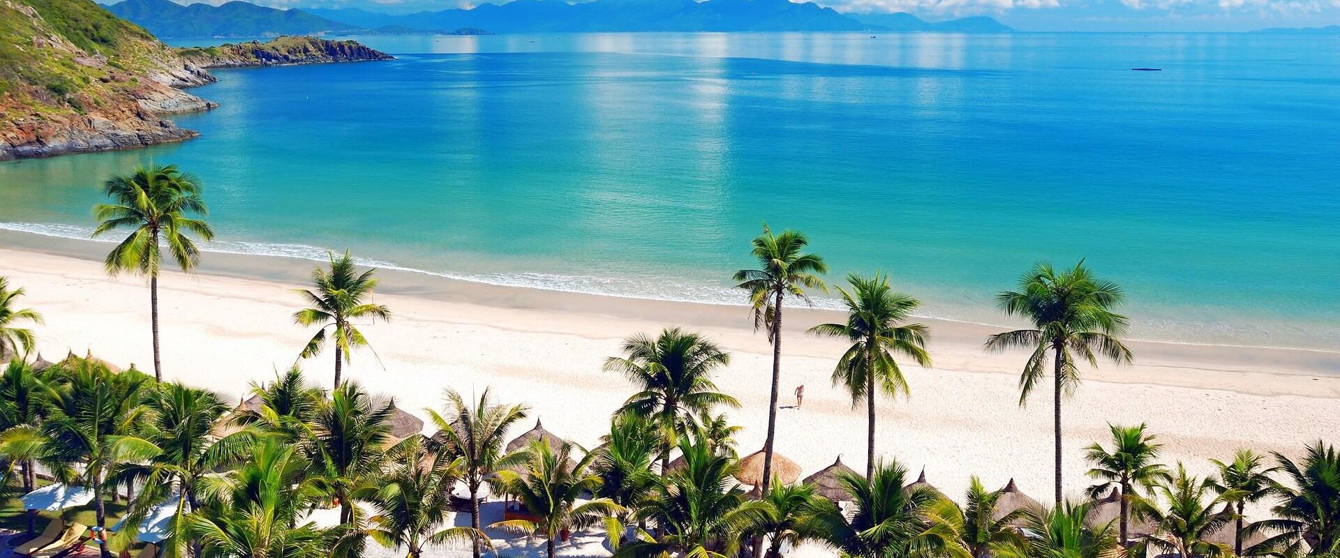 Turquoise Nha Trang Bay in Khanh Hoa on a scenic Nha Trang Travel banner by Legend Travel Group.